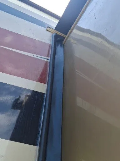 Close-up of worn exterior seal material on an RV